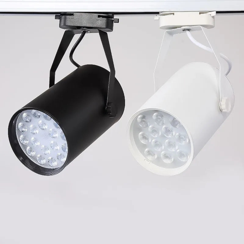 Black and white aluminium shell LED track spotlight mounted on a lighting track for display use.