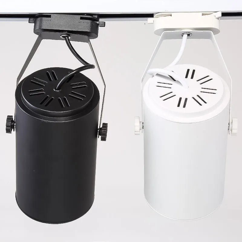 Black and white aluminium shell LED track spotlight mounted on a lighting track for display use.
