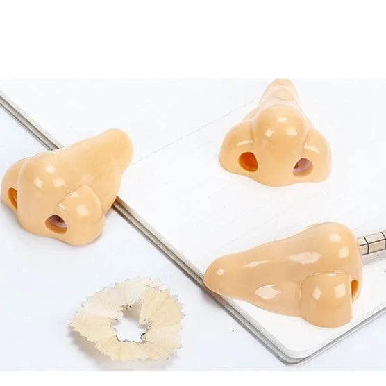 Flesh-coloured geometry-shaped pencil sharpener with big nostril design measuring 58x45x30mm