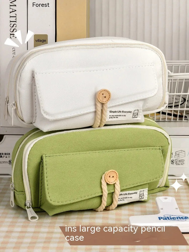 Korean style canvas pencil case in green holding multiple pens
