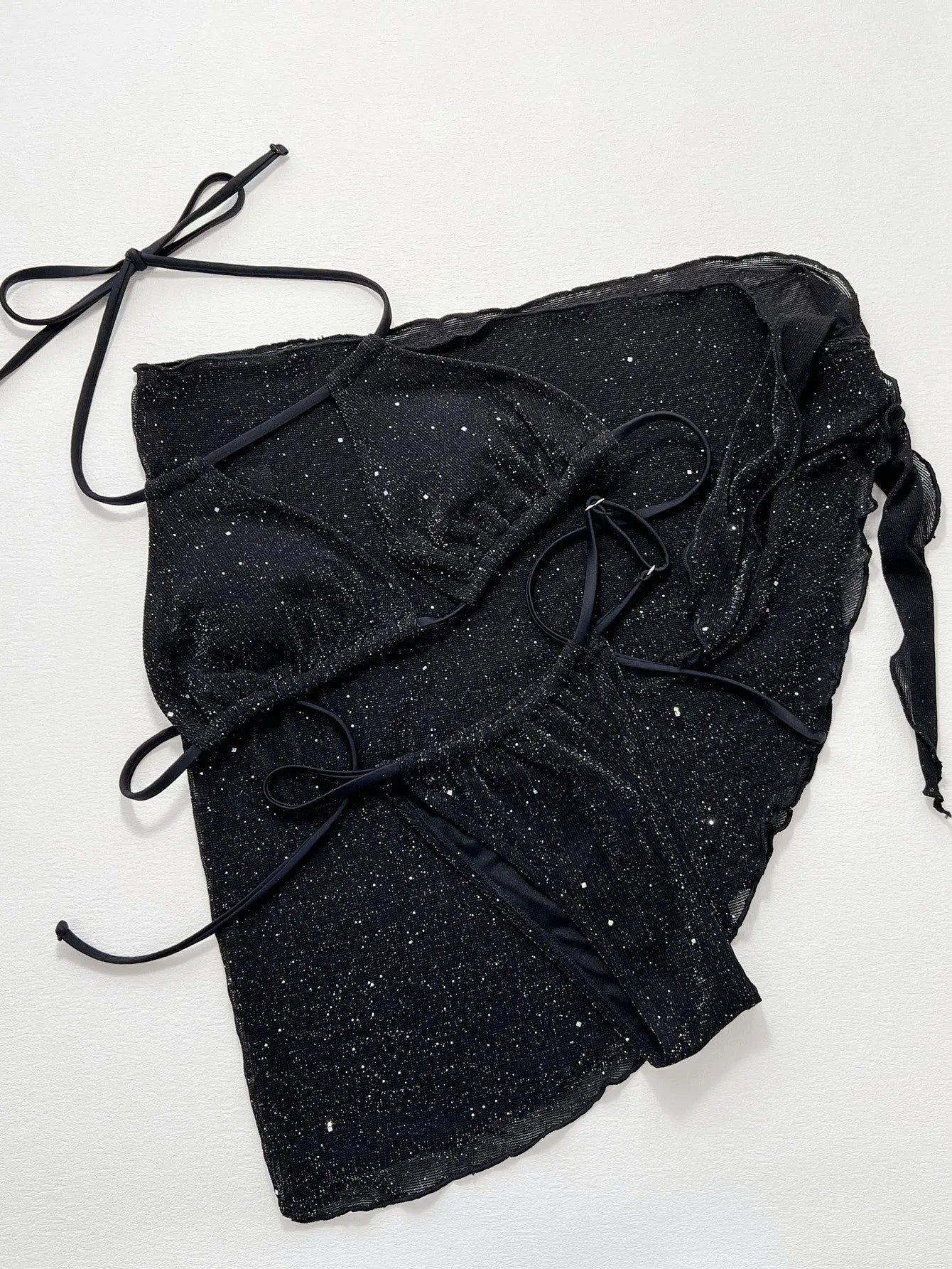 Black three-piece bikini swimsuit set with top and shorts on a mannequin