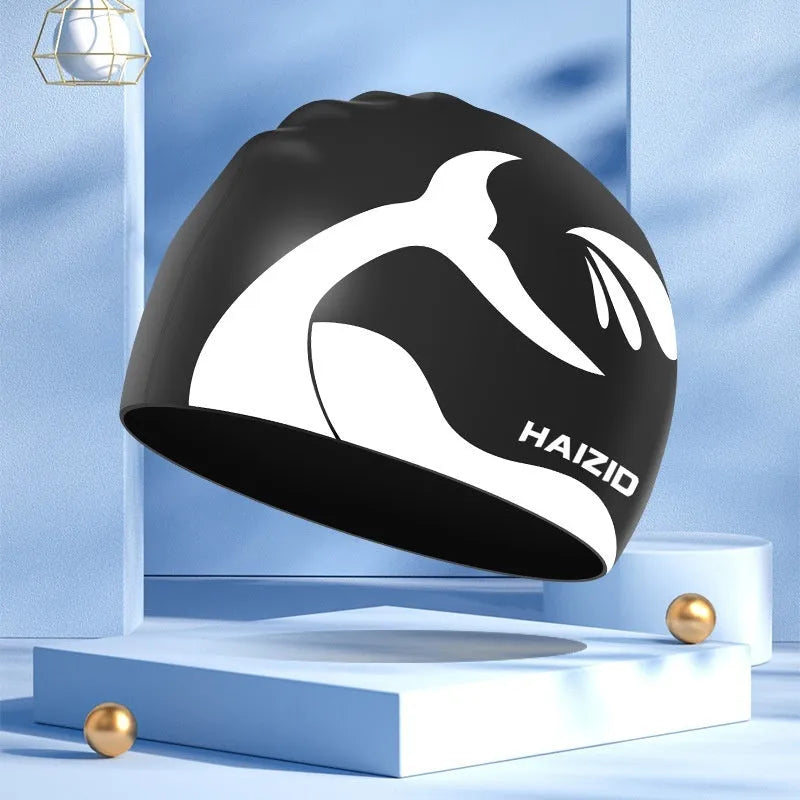 Silicone swimming cap with waterproof ear protectors featuring whale tail pattern design