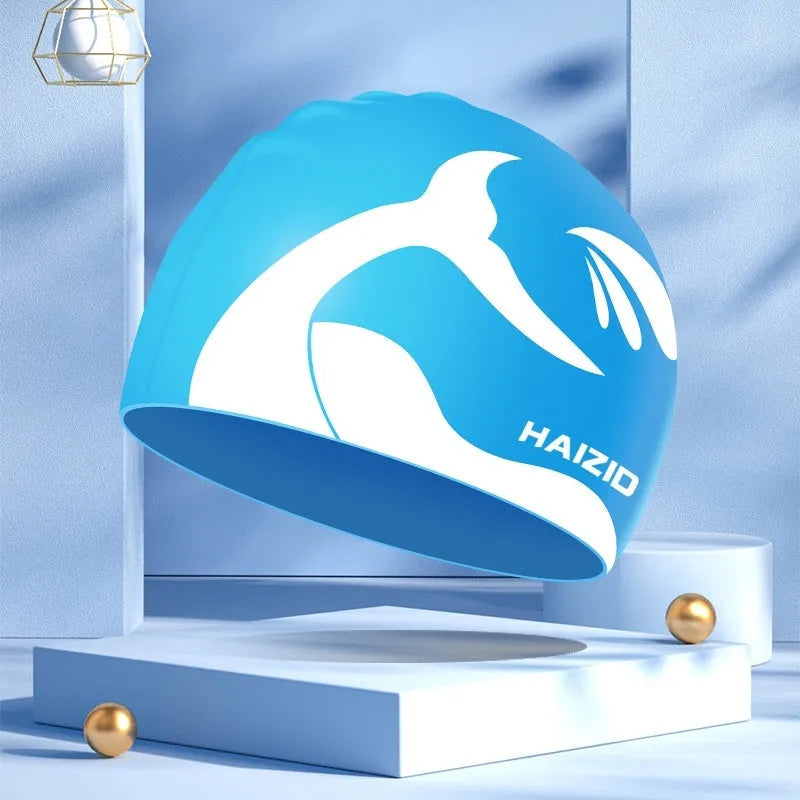 Silicone swimming cap with waterproof ear protectors featuring whale tail pattern design