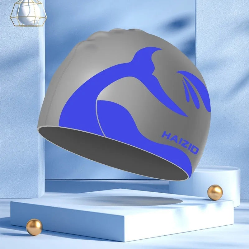Silicone swimming cap with waterproof ear protectors featuring whale tail pattern design