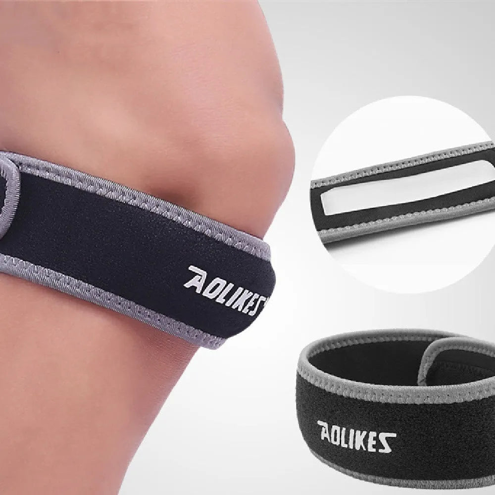 Black and grey elastic patella retinaculum knee support pad for sports.