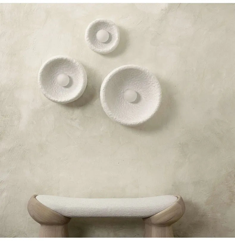 Japanese-style simple silent wall lamp with resin shade in three diameter sizes on white wall