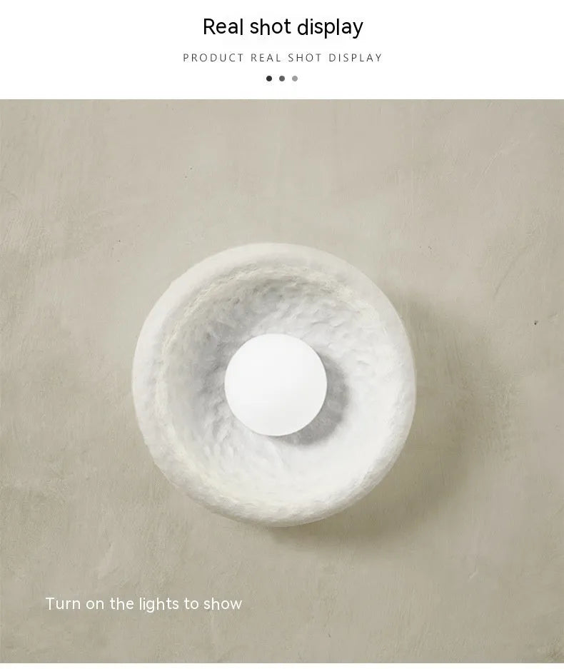 Japanese-style simple silent wall lamp with resin shade in three diameter sizes on white wall