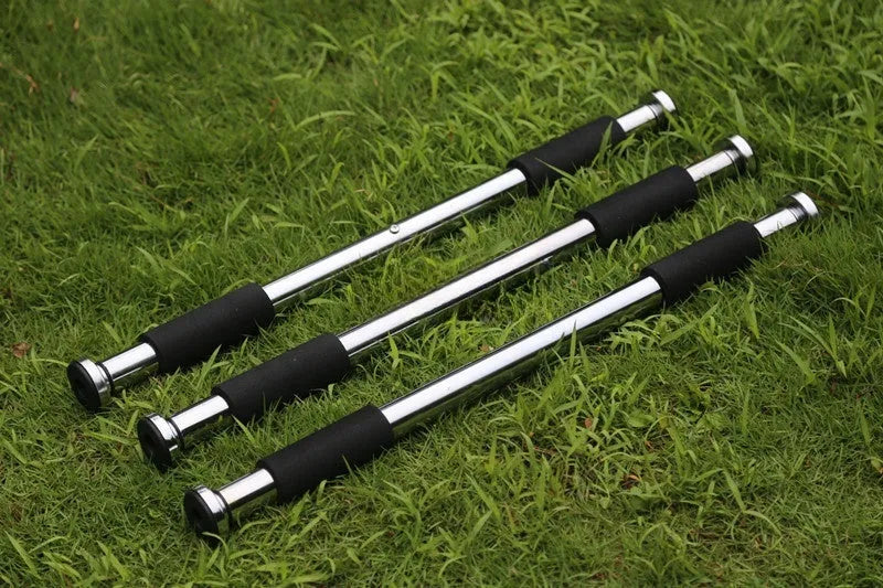 Steel adjustable pull-up bar mounted in a door frame for home fitness workouts