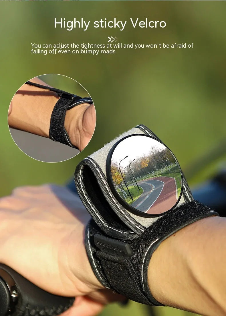 Black nylon wrist-mounted rear-view mirror for bicycles on a cyclist's wrist.