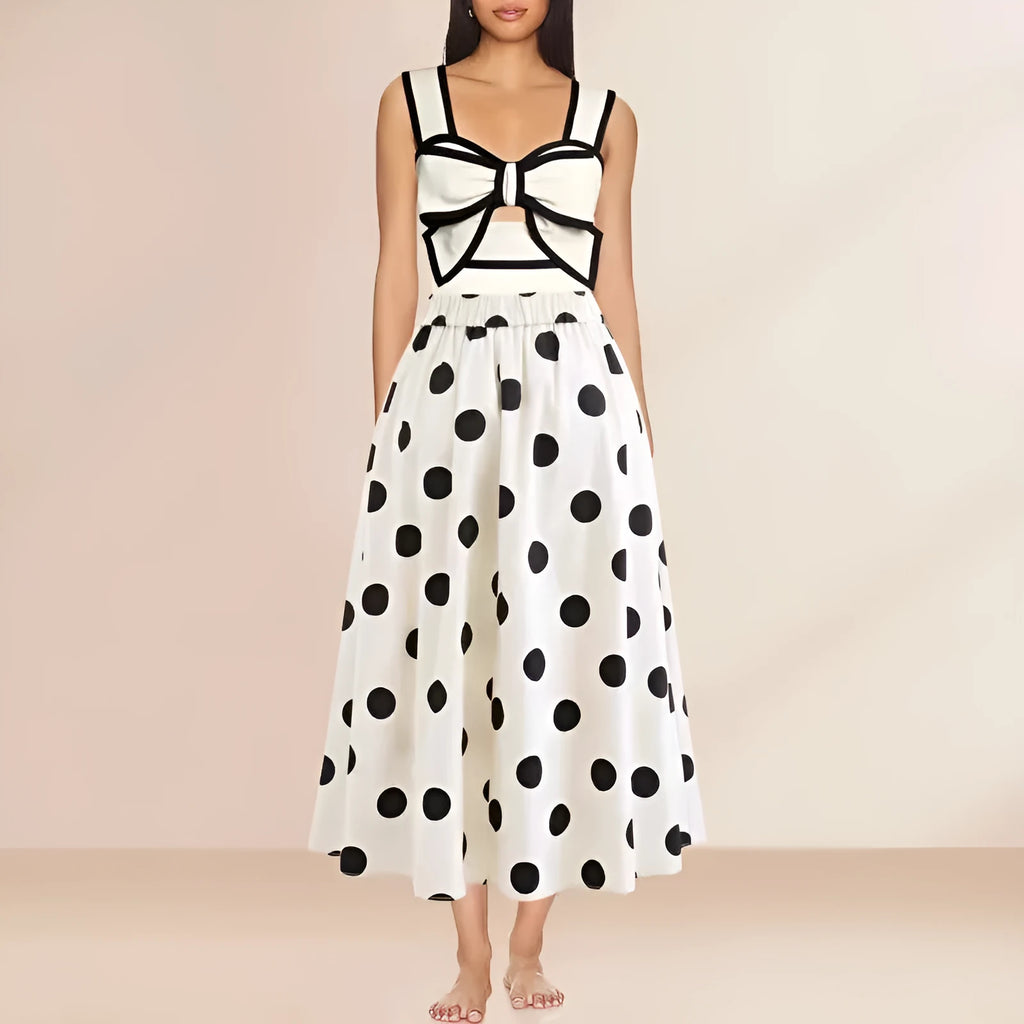 Women's black one-piece swimsuit with a white round skirt and a bow detail at the front.