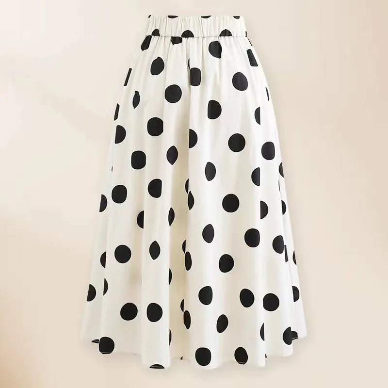 Women's black one-piece swimsuit with a white round skirt and a bow detail at the front.