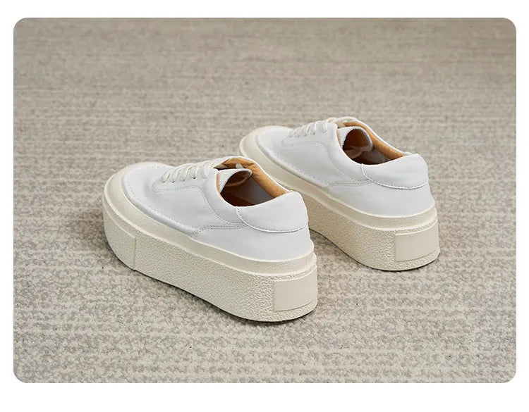 Women's black platform casual sports shoes with embossed leather upper and round toe.