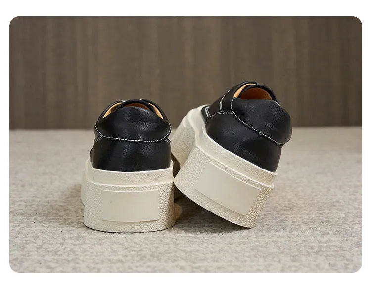Women's black platform casual sports shoes with embossed leather upper and round toe.