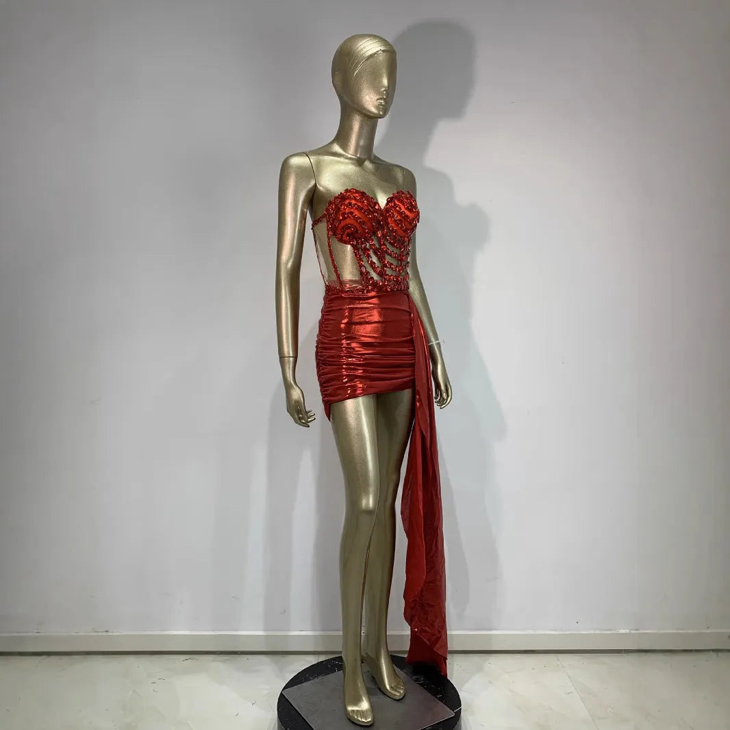 Red women's skirt suit with see-through mesh panels, made from stretch spandex fabric.