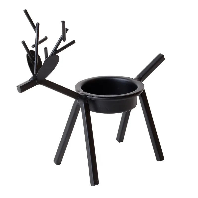 Black iron deer-shaped candlestick holder with fabric decorative elements for Christmas table decoration.