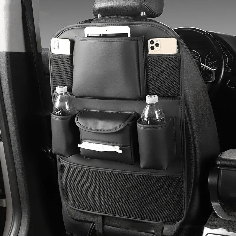 Genuine leather car seat back storage bag shown in grey, suspended behind a car headrest.