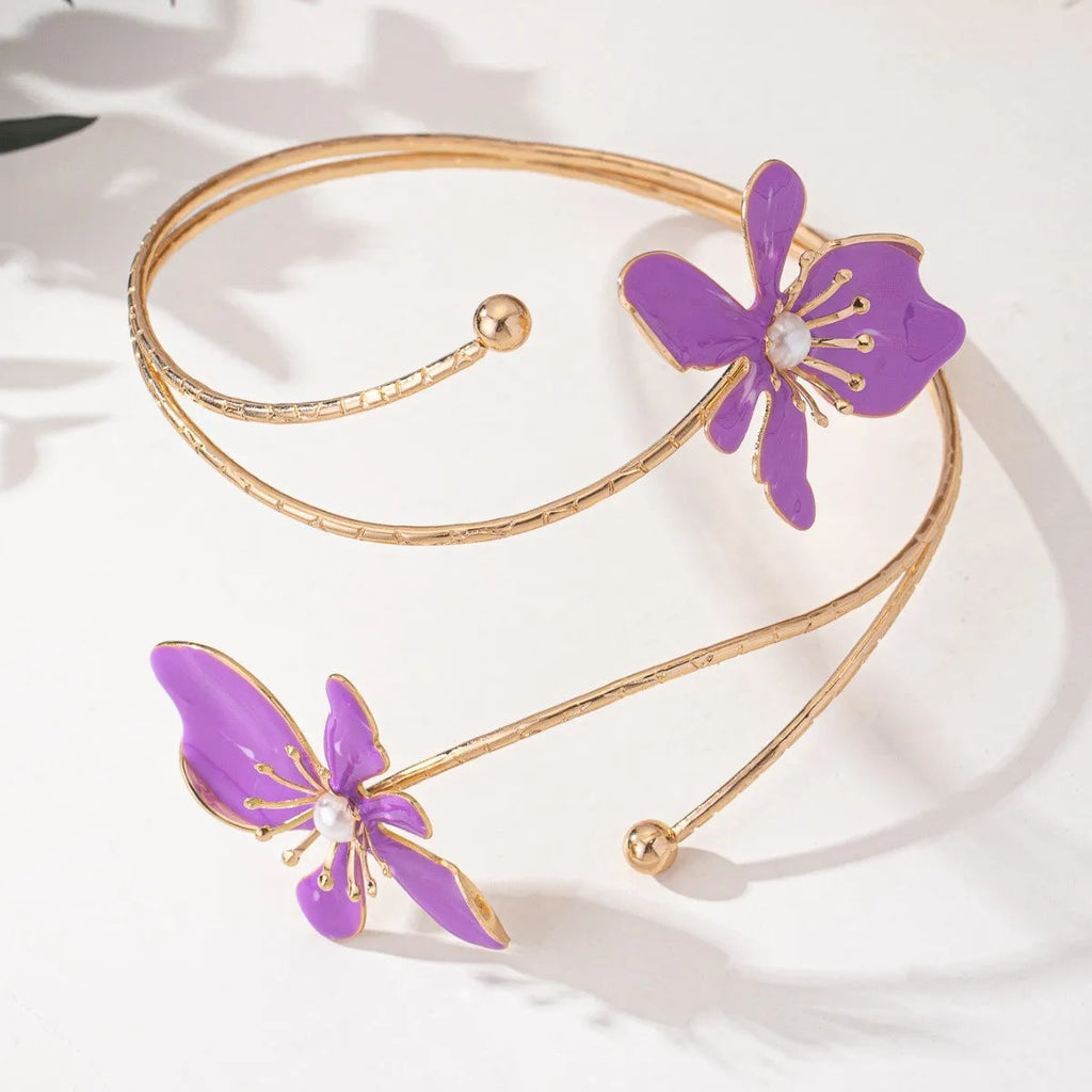Pink alloy fashion armband with a hollow, openwork pattern shown on a wrist.