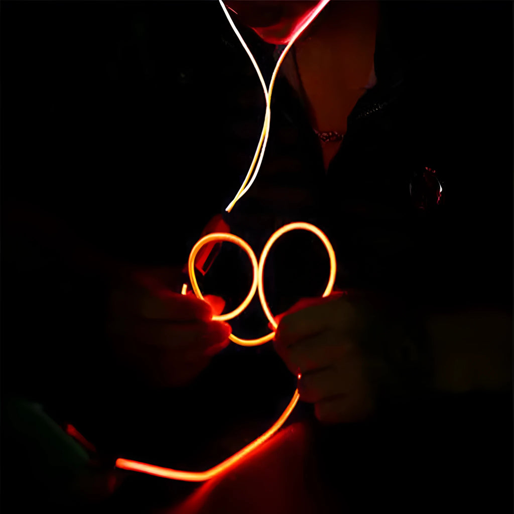 Blue light-up LED earphones with aluminium shells, remote control, and 3.5mm plug on a white background.