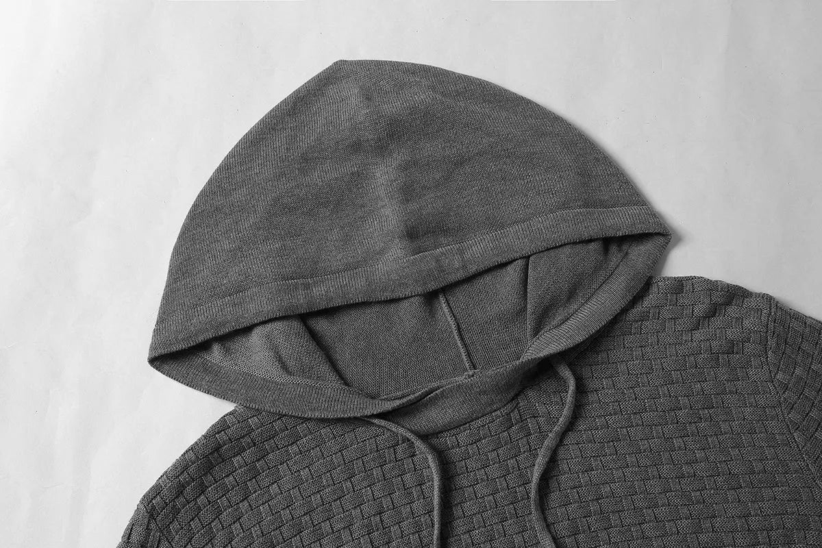 A man wearing a zip-up cotton blend hoodie in navy blue, showing the front kangaroo pocket and hood.