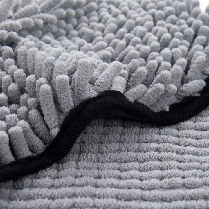 Blue pet bath robe towel for drying a dog after a wash, showing its size and soft texture.