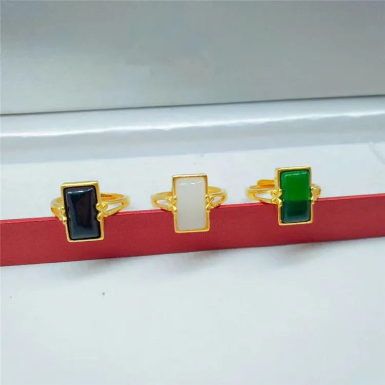 Adjustable brass gold-plated ring with gemstone in green, white or black options showing adjustable port mechanism