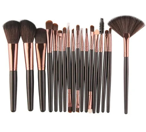 MAANGE 18-piece makeup brush set with fan-shaped cosmetic tools laid out on a table.