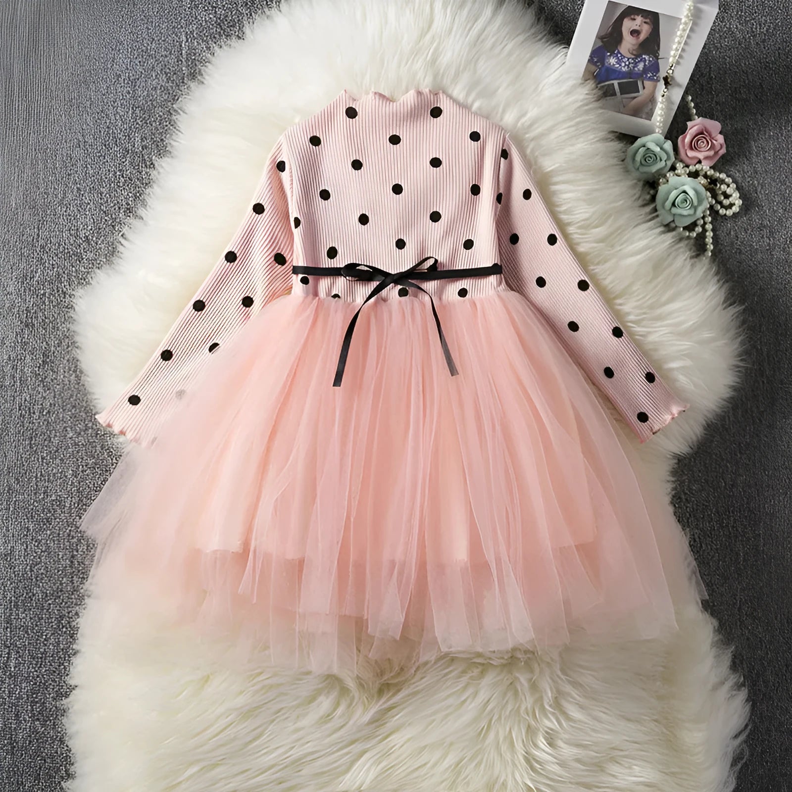 Baby girl wearing a long sleeve lace and tutu dress in pink, suitable for a birthday party.