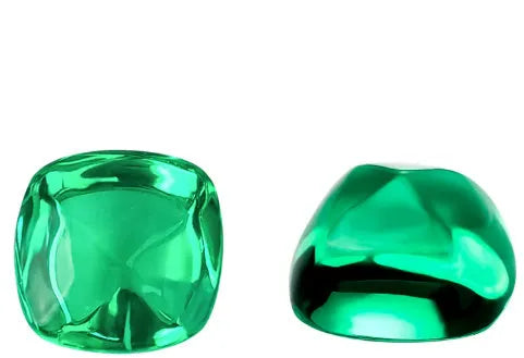 Cultivated emerald gemstone in Columbian green colour showing various polished cuts on a white background.