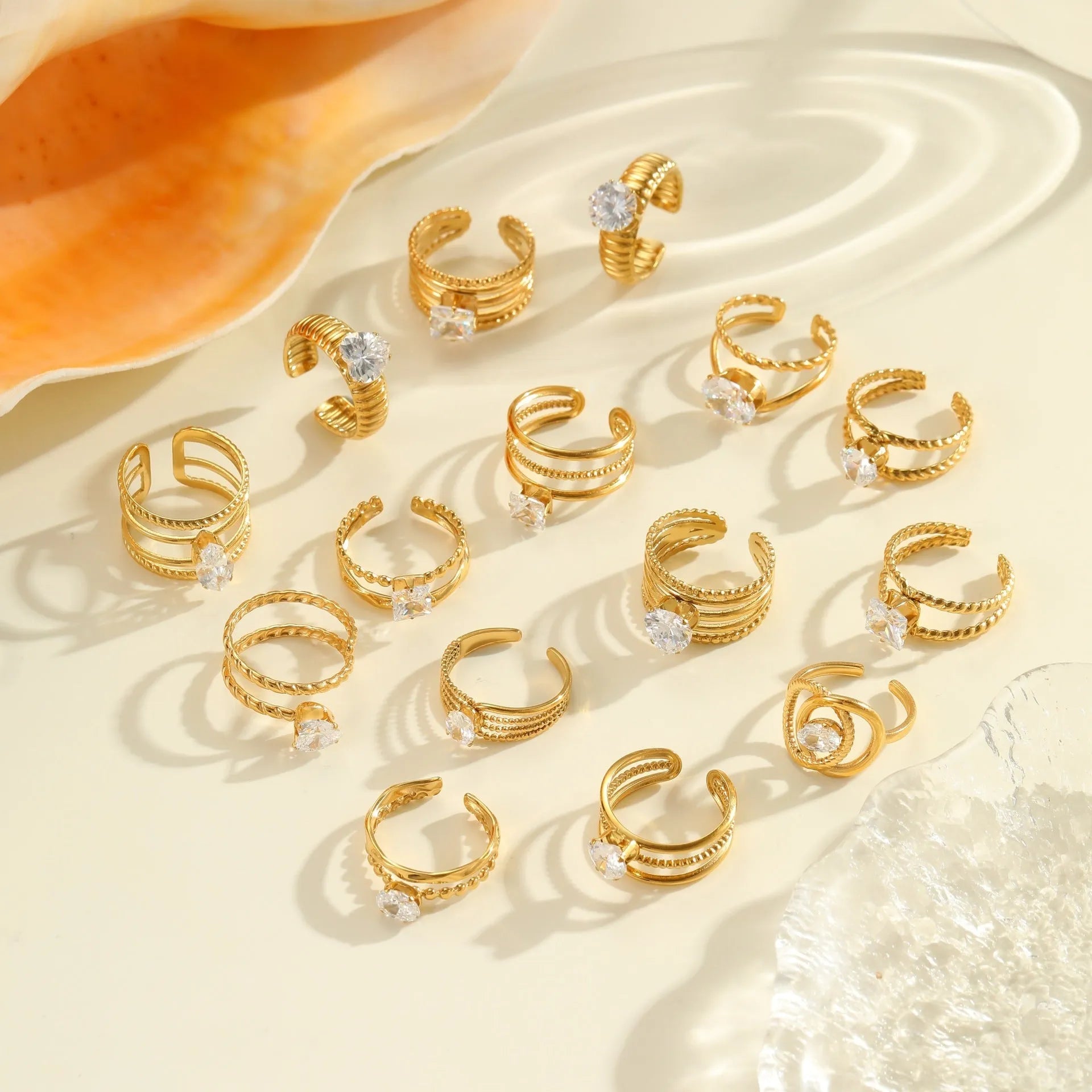 Gold-plated geometric stainless steel ring with inlaid zircon stones on a white background.