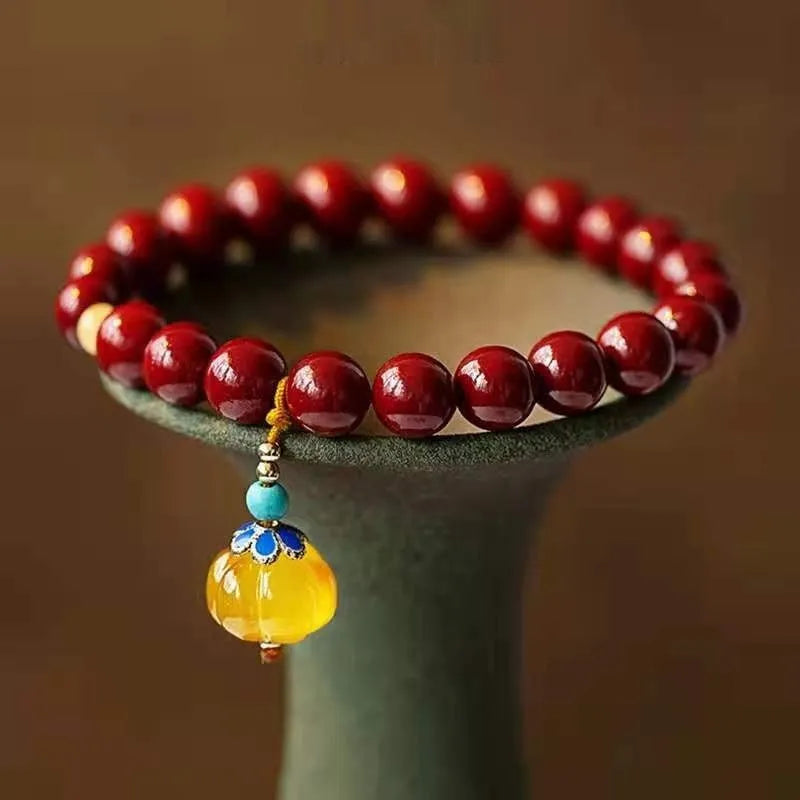 Handmade gold cinnabar wave bracelet with copper beads in national style unisex design.