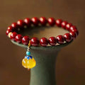 Handmade gold cinnabar wave bracelet with copper beads in national style unisex design.