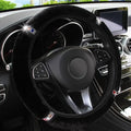 Short hair diamond plush elastic steering wheel cover in black on a car steering wheel