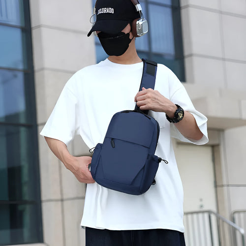Men's grey waterproof chest bag with shoulder strap showing 33cm height dimensions