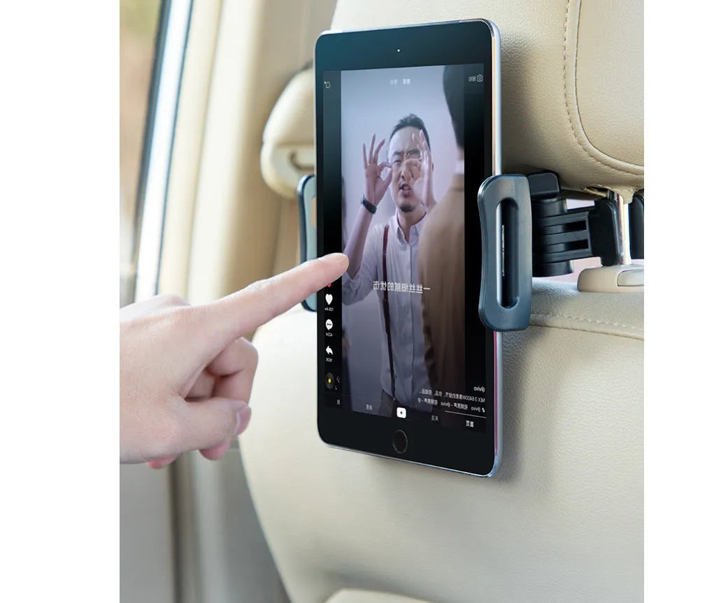 Black car phone holder mounted on rear seat headrest with tablet securely positioned