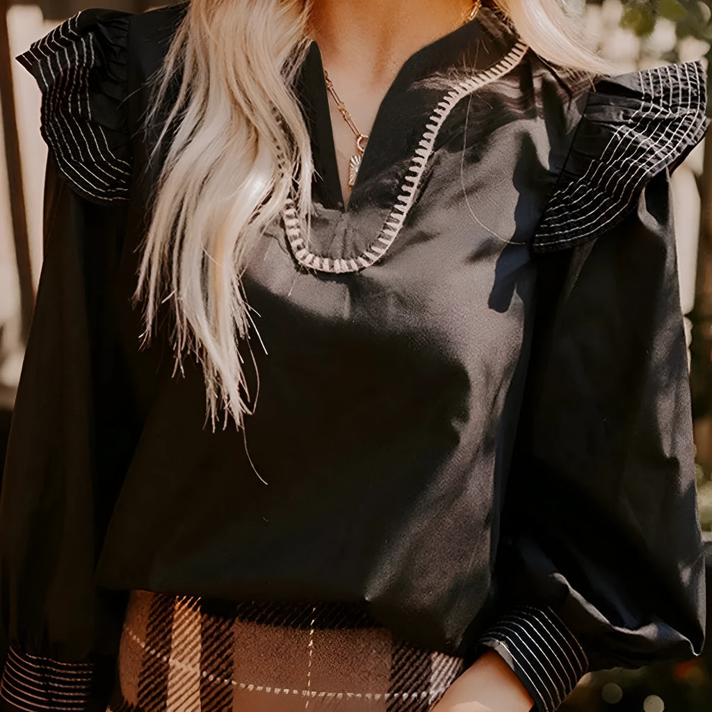 Black women's V-neck blouse with contrast stitching and long ruffle sleeves
