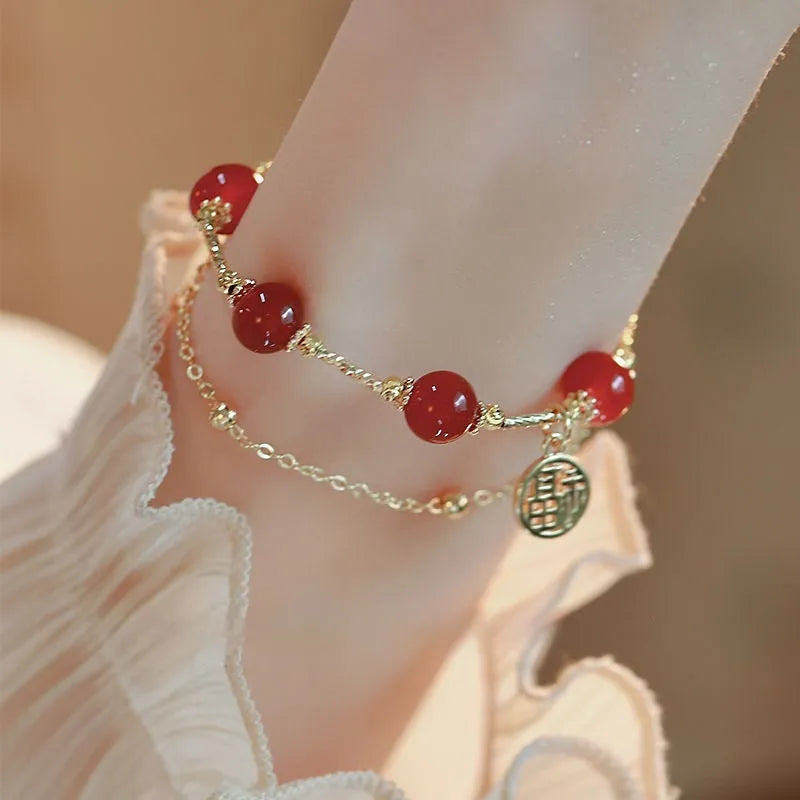 Red agate blessing card double-layer bracelet on display with alloy electroplated finish and chamfered square pattern