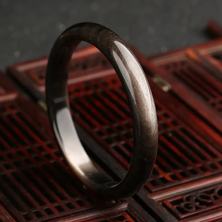 Natural silver cat's eye crystal and alloy bracelet with retro geometric ethnic design on a wrist.