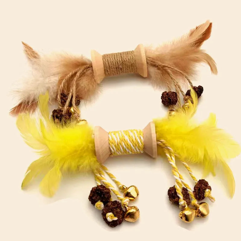 Feather bell gall fruit cat toy in ginger colour with bells and feathers on green background