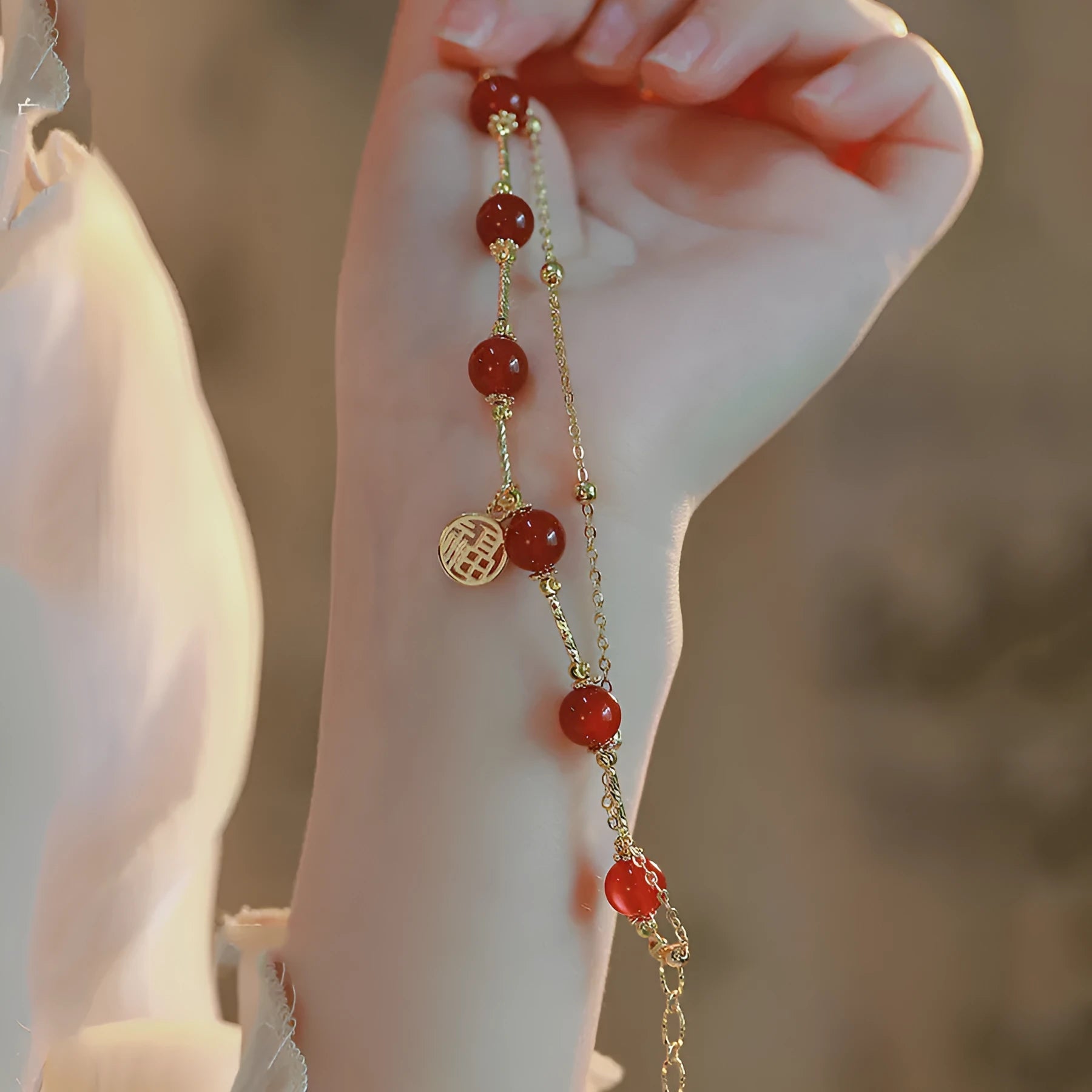 Red agate blessing card double-layer bracelet on display with alloy electroplated finish and chamfered square pattern