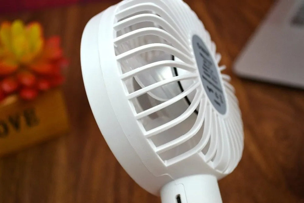 White portable USB desk fan with rechargeable battery, showing three-speed controls and compact design