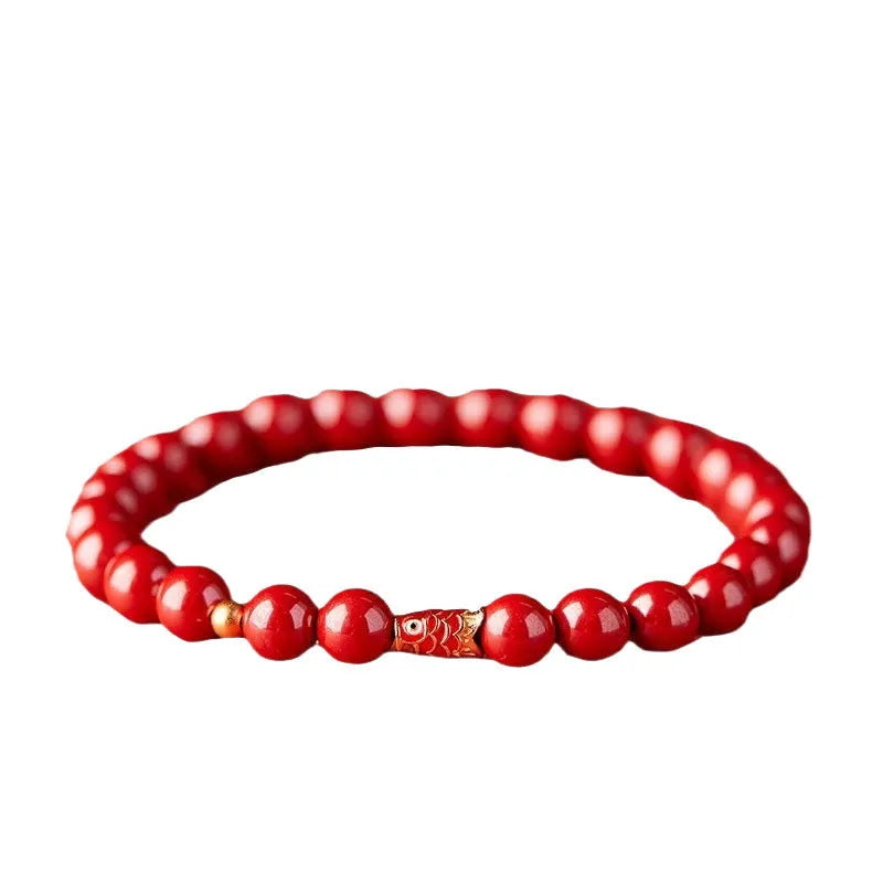 Natural cinnabar koi carp bracelet with gold ball in 4mm or 6mm size on wrist.