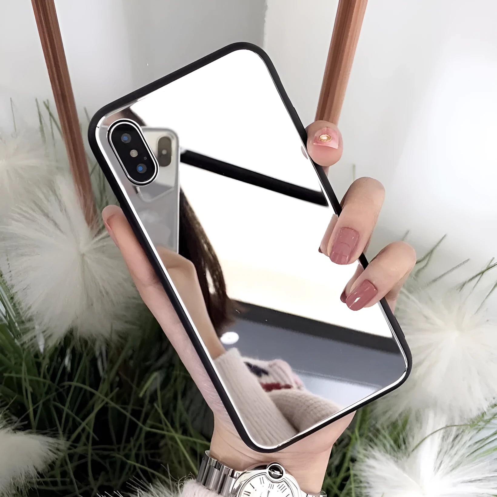 Black mirror iPhone back cover case for iPhone 7 Plus, 8 Plus, and X models on a table.