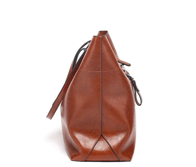 Brown waxed cowhide leather crossbody handbag showing two compartments and phone pocket