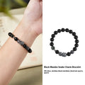 Men's obsidian black snake bracelet made of sterling silver with retro zodiac styling on a wrist.