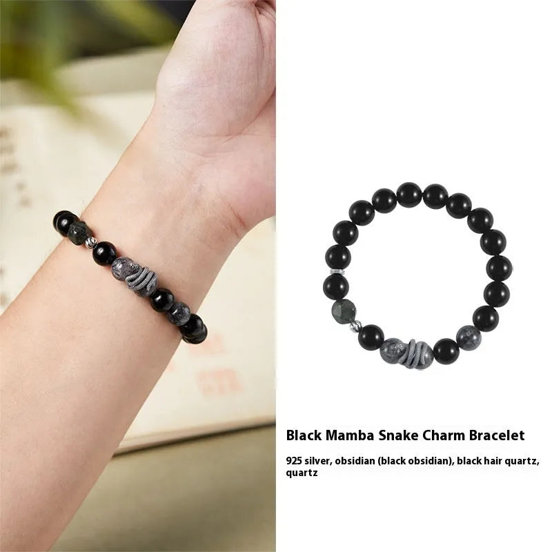 Men's obsidian black snake bracelet made of sterling silver with retro zodiac styling on a wrist.