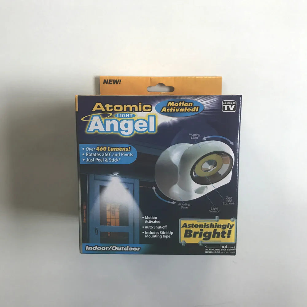 White Atomic Angel induction light unit on a surface showing its compact size.