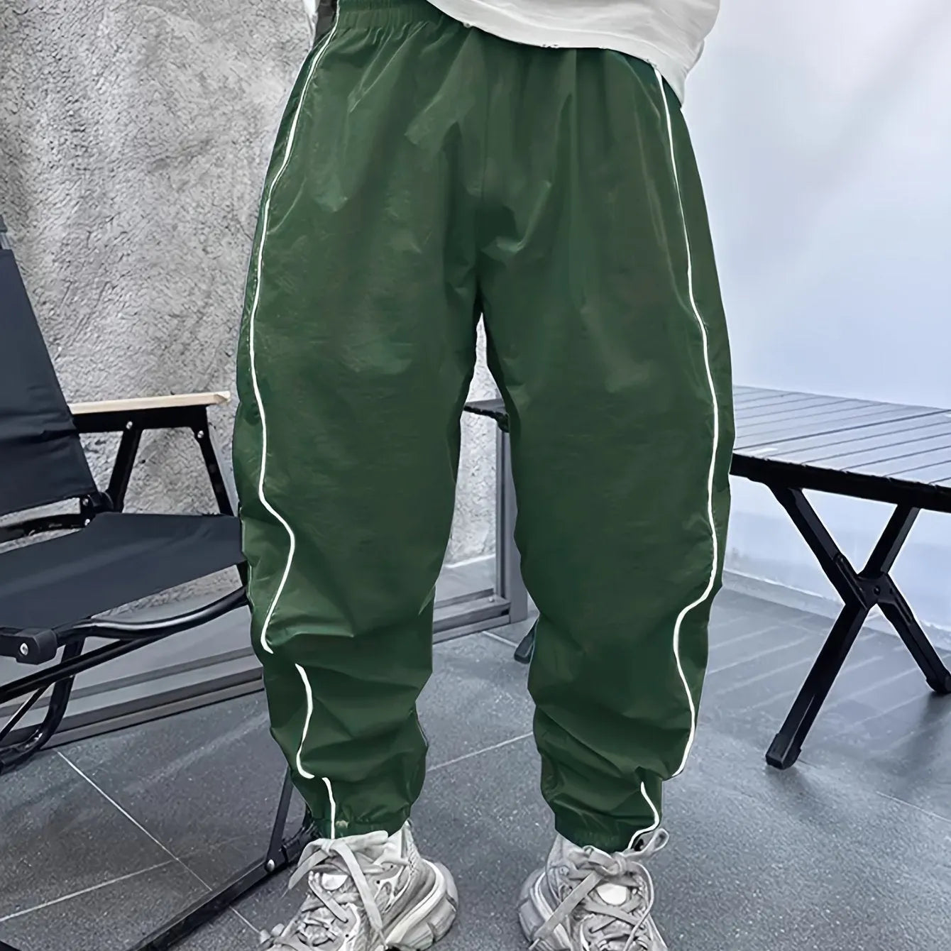 Men's loose blue bamboo fibre cropped sports trousers on a grey background