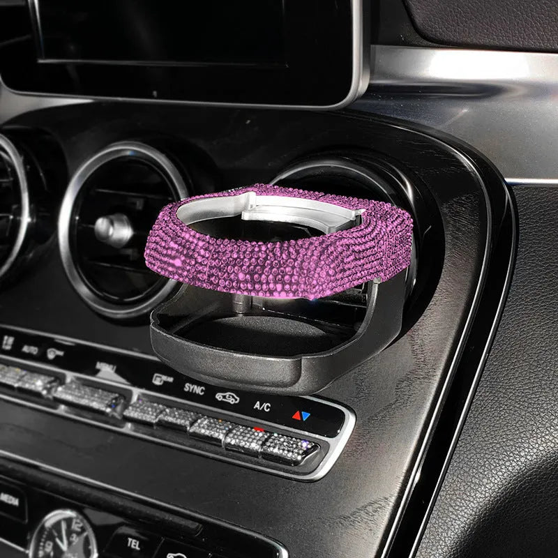 White diamond-encrusted ABS plastic car cup holder bracket mounted on a car air vent.