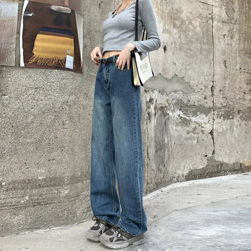 Women's retro blue high-waisted straight-leg jeans on a hanger, showing front detail.