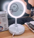 White foldable LED vanity mirror with double-sided magnification and USB charging port